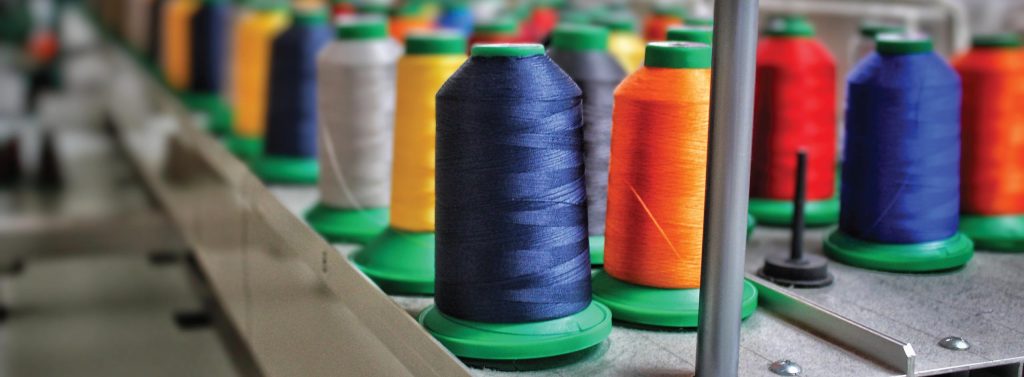 Colorful embroidery thread spools on industrial sewing machine